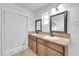 Bathroom featuring double vanity with granite countertops and framed mirrors at 2410 N 40Th St, Phoenix, AZ 85008