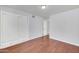 Bedroom with wood laminate flooring and closet with white sliding doors at 2410 N 40Th St, Phoenix, AZ 85008