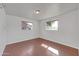 Bedroom with two windows and wood laminate flooring at 2410 N 40Th St, Phoenix, AZ 85008