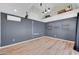 Spacious bonus room with wood floors, shelving, and modern fixtures perfect for various activities at 2410 N 40Th St, Phoenix, AZ 85008
