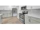 Well-lit kitchen featuring stainless appliances, ample cabinetry and sleek countertops at 2410 N 40Th St, Phoenix, AZ 85008