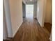 Spacious hallway featuring wood-style tile flooring and neutral wall colors at 25351 W Bowker St, Buckeye, AZ 85326