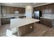 Modern kitchen with stainless steel appliances, a large island, and ample cabinet space at 25351 W Bowker St, Buckeye, AZ 85326