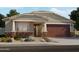 Charming single-story home with stone accents, covered porch, two-car garage and landscaped front yard at 25736 N 159Th Ln, Surprise, AZ 85387