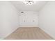 A bright and airy bedroom featuring a modern light fixture and two closets at 2625 W Ocotillo Rd # 4, Phoenix, AZ 85017