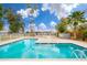 Inviting community pool with clear blue water, surrounded by palm trees and a well-maintained deck at 2625 W Ocotillo Rd # 4, Phoenix, AZ 85017