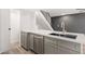 Kitchen island with a stainless steel dishwasher, gray cabinets, and a white countertop at 2625 W Ocotillo Rd # 4, Phoenix, AZ 85017