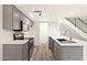 Stylish kitchen featuring gray cabinets, stainless steel appliances, and a breakfast bar with a modern faucet at 2625 W Ocotillo Rd # 4, Phoenix, AZ 85017