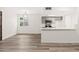 Open living space with wood-look floors, a view of the kitchen, and a window for natural light at 2625 W Ocotillo Rd # 4, Phoenix, AZ 85017