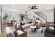 Bright living room showcasing a spacious layout, modern decor, and seamless flow to the kitchen and staircase at 2625 W Ocotillo Rd # 4, Phoenix, AZ 85017