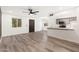 Bright and airy living area with wood-look floors, a view of the kitchen, and access to the front door at 2625 W Ocotillo Rd # 4, Phoenix, AZ 85017