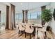 Elegant dining room featuring a modern table, seating for eight, and lots of natural light at 2912 E Lucky Horseshoe Ln, San Tan Valley, AZ 85140