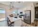 Modern kitchen with stainless steel appliances, an island with seating, and pendant lighting at 2912 E Lucky Horseshoe Ln, San Tan Valley, AZ 85140