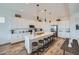 Spacious kitchen with white cabinets, large island, stylish pendants and stainless-steel appliances at 2912 E Lucky Horseshoe Ln, San Tan Valley, AZ 85140
