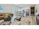 Open-concept living space with kitchen island, modern furniture, and wood-look tile flooring at 2912 E Lucky Horseshoe Ln, San Tan Valley, AZ 85140