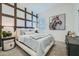 Tastefully decorated main bedroom with modern furniture and decorative painting on accent wall at 2912 E Lucky Horseshoe Ln, San Tan Valley, AZ 85140