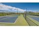 Outdoor pickleball courts with green and blue surface and black chainlink fence under bright sky at 2912 E Lucky Horseshoe Ln, San Tan Valley, AZ 85140
