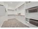 Spacious walk-in closet featuring ample shelving, wooden rods, and soft, neutral carpeting for organized storage at 2912 E Lucky Horseshoe Ln, San Tan Valley, AZ 85140