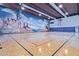 Indoor basketball court with a mural, offering residents an athletic recreational area inside the community center at 3031 N Civic Center Plz # 340, Scottsdale, AZ 85251