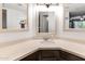 Bright bathroom with a large vanity, dual mirrors, updated faucet fixtures and a unique corner design at 3031 N Civic Center Plz # 340, Scottsdale, AZ 85251