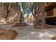 Community courtyard with fountain, mature trees, and walking paths between buildings at 3031 N Civic Center Plz # 340, Scottsdale, AZ 85251