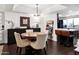 Stylish dining area open to kitchen with modern chandelier and dark wood flooring throughout at 3031 N Civic Center Plz # 340, Scottsdale, AZ 85251
