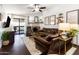 Inviting living room with a decorative fireplace, sliding glass doors, and comfortable brown leather furniture at 3031 N Civic Center Plz # 340, Scottsdale, AZ 85251