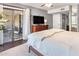 Comfortable main bedroom features balcony access, ceiling fan, and dresser with mounted television at 3031 N Civic Center Plz # 340, Scottsdale, AZ 85251