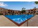 Inviting pool featuring clear blue water, lounge chairs, and community buildings on a sunny day with a blue sky at 3031 N Civic Center Plz # 340, Scottsdale, AZ 85251