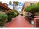 Red brick paved walkway with lush landscaping, a barbecue grill, and gas propane tank, enhancing outdoor community living at 3031 N Civic Center Plz # 340, Scottsdale, AZ 85251