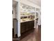 This wet bar features plentiful glass shelving and dark wooden cabinets at 3031 N Civic Center Plz # 340, Scottsdale, AZ 85251