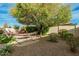 Relaxing backyard featuring a hammock, patio seating, and mature landscaping at 3080 E Palmdale Ln, Gilbert, AZ 85298