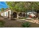 Lush backyard with a hammock, patio seating, mature landscaping, and block wall at 3080 E Palmdale Ln, Gilbert, AZ 85298