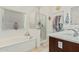 Bright bathroom featuring a soaking tub, glass enclosed shower, and modern vanity at 3080 E Palmdale Ln, Gilbert, AZ 85298