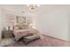 Comfortable bedroom features soft pink accents, plush rug and ample natural light at 3080 E Palmdale Ln, Gilbert, AZ 85298