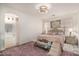 Cozy bedroom boasts soft pink accents, a plush rug, and ample natural light at 3080 E Palmdale Ln, Gilbert, AZ 85298