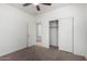 This bright bedroom features plush carpet, a closet, and a doorway to another room at 3080 E Palmdale Ln, Gilbert, AZ 85298