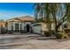 Inviting single-story home featuring a large front yard, desert landscaping, and a two-car garage at 3080 E Palmdale Ln, Gilbert, AZ 85298