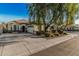Inviting single-story home featuring a large front yard, desert landscaping, and a two-car garage at 3080 E Palmdale Ln, Gilbert, AZ 85298