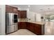 Bright kitchen with stainless steel refrigerator, granite countertops, and tile floors at 3080 E Palmdale Ln, Gilbert, AZ 85298