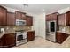 Well-equipped kitchen features stainless steel appliances, granite countertops, and rich wood cabinetry at 3080 E Palmdale Ln, Gilbert, AZ 85298