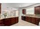 Open kitchen with granite countertops and plenty of cabinetry offers easy access to living area at 3080 E Palmdale Ln, Gilbert, AZ 85298