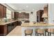 Well-equipped kitchen with stainless steel appliances, granite countertops, and island seating at 3080 E Palmdale Ln, Gilbert, AZ 85298