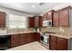 Charming kitchen features stainless appliances, granite countertops, and tile flooring at 3080 E Palmdale Ln, Gilbert, AZ 85298