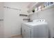 Bright laundry room featuring a modern washer and dryer and ample shelving for storage and organization at 3080 E Palmdale Ln, Gilbert, AZ 85298