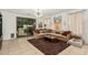 Bright living room showcasing a modern chandelier, neutral sofa, and access to the backyard at 3080 E Palmdale Ln, Gilbert, AZ 85298