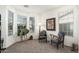 Sunlit sitting room featuring large windows, cozy chairs, and neutral carpet at 3080 E Palmdale Ln, Gilbert, AZ 85298