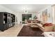 Bright living room showcasing a modern chandelier, neutral sofa, and access to the backyard at 3080 E Palmdale Ln, Gilbert, AZ 85298