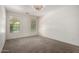 Spacious main bedroom features plush carpeting, two windows, and neutral decor at 3080 E Palmdale Ln, Gilbert, AZ 85298