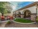Charming covered patio with stone pillars and well manicured turf, perfect for relaxing at 3080 E Palmdale Ln, Gilbert, AZ 85298